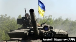 UKRAINE – Ukrainian troop ride a tank on a road of the eastern Ukrainian region of Donbas on June 21, 2022